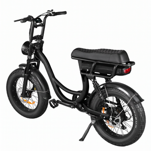 Rear three-quarter view of a matte black step-through electric bike with wide fat tires, round LED headlight, and high handlebars