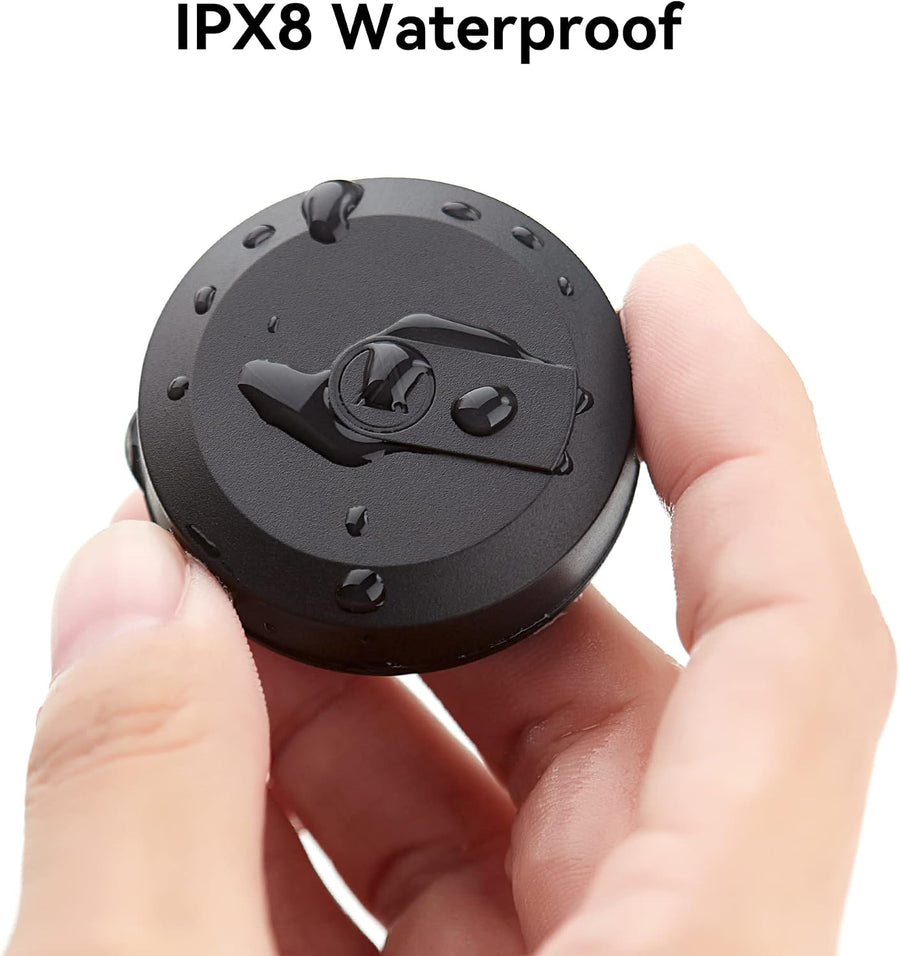 Hidden AirTag holder held between two fingers, covered in water droplets